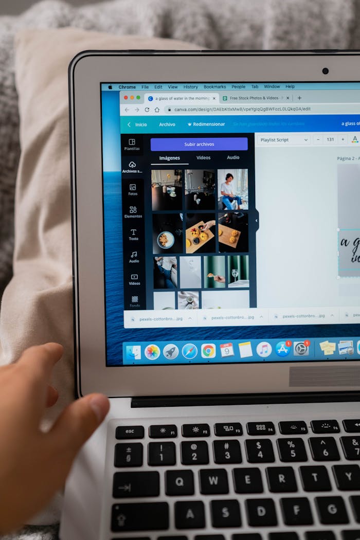 A person using design software on a laptop, showcasing creative work.